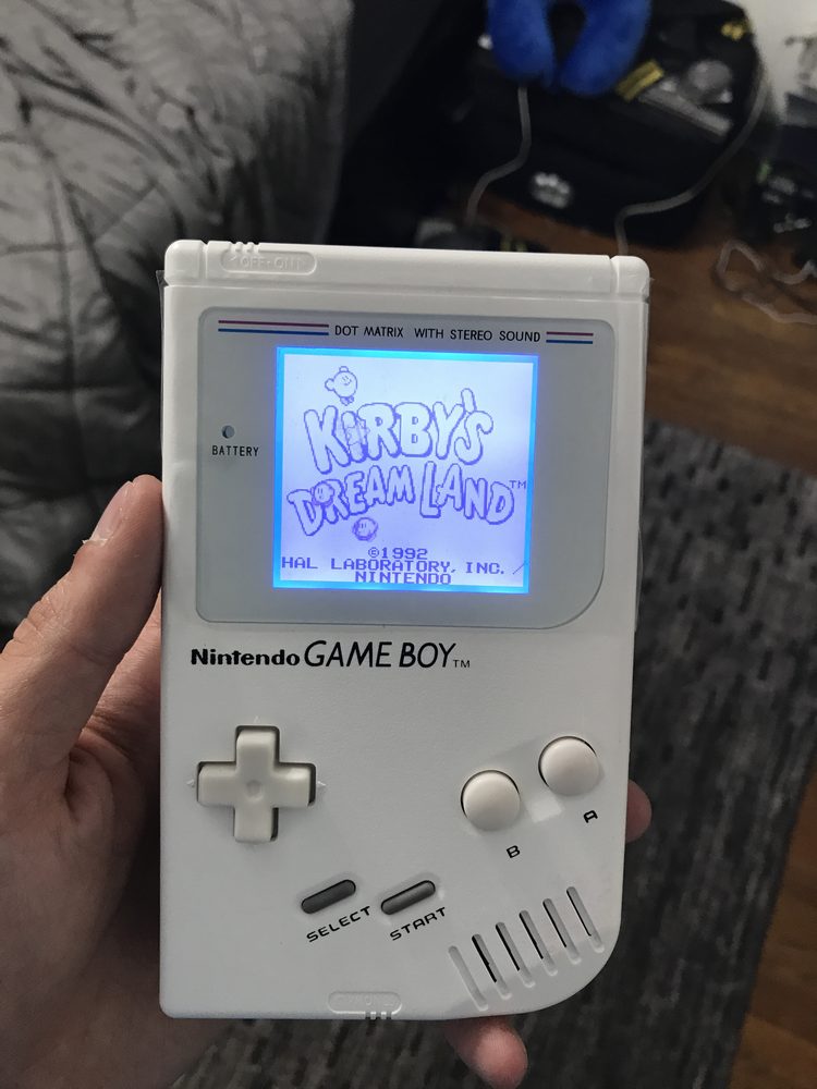 All white Gameboy DMG with backlit screen.
